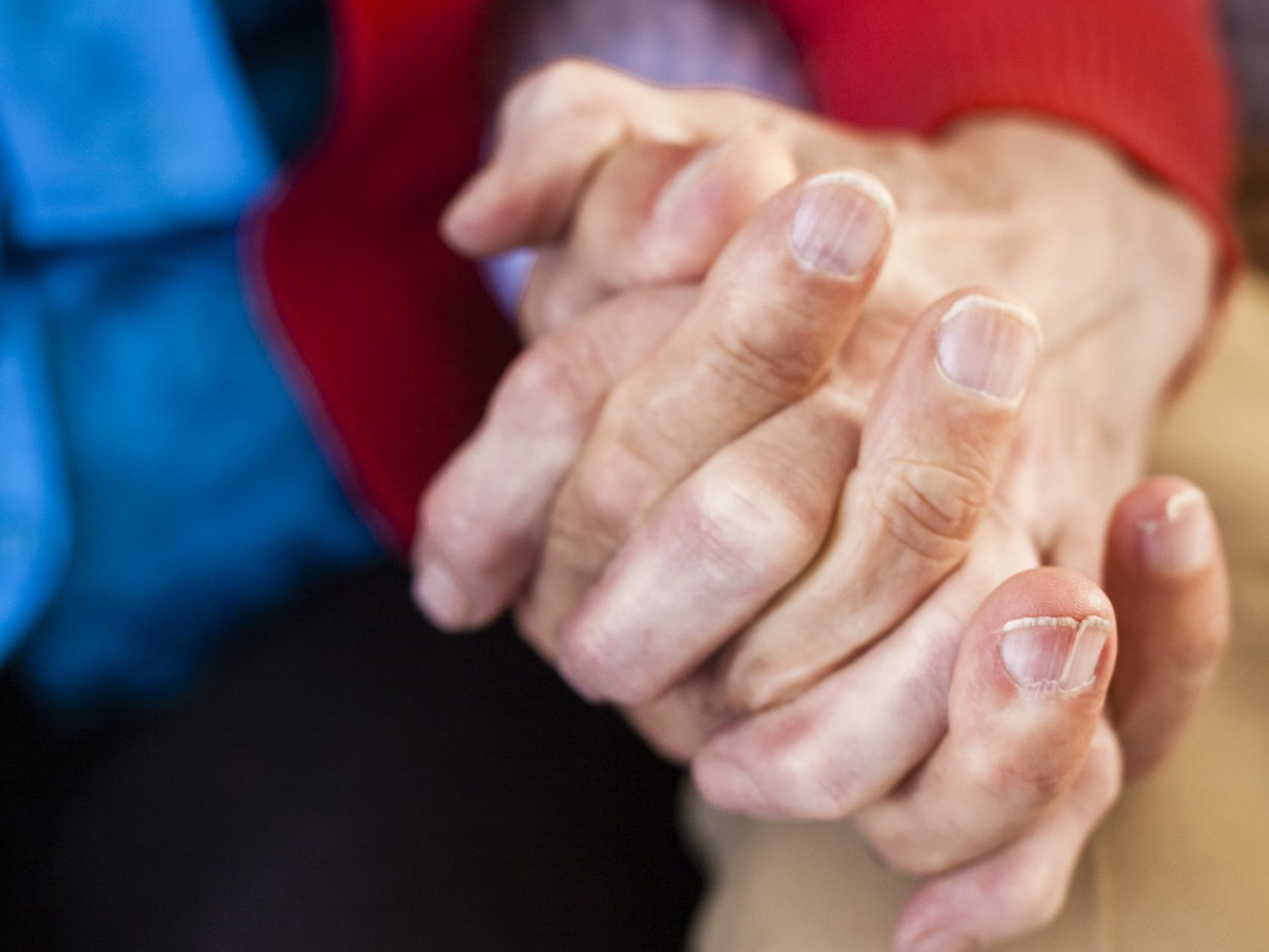 close-up-senior-couple-holding-hands
